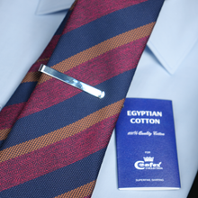 a close up of a tie with a badge on it