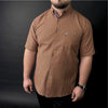 a man wearing a brown and black checkered shirt