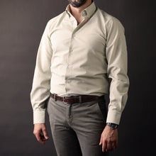 a man wearing a white shirt and a brown belt