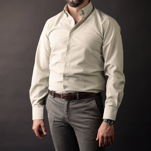 a man wearing a white shirt and a brown belt