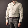 a man wearing a white shirt and a brown belt