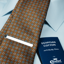 a close up of a tie and a passport