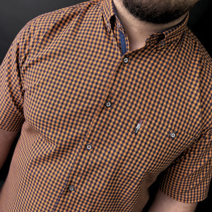 a man with a beard wearing a checkered shirt